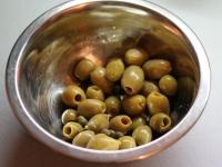 Let the olives and capers drain. Put them in the...