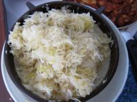 Squeeze the sauerkraut out and use a sieve to wash...