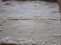 Use a rolling pin to spread the dough on a well...