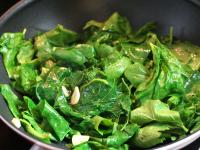 Fry spinach and garlic in oil. Remove from the...