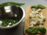 Shuckle peas, cut feta into squares and basil...