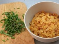 Cut basil leaves into small pieces. Put cornflakes...