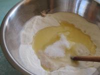 Pour flour in a bowl and make a small hole for the...