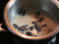 Flakes with chopped prunes simmer in water over a...