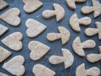 Place honey cookies on the greased tray, brush...