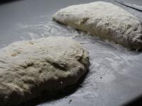 Transfer the raised dough to the floured board....