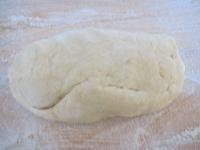 Use a rolling pin to spread the dough on floured...