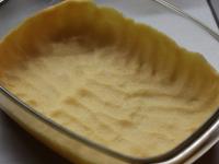 Place the dough into a baking tin and stretch it...