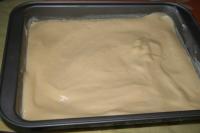 Spread dough over the greased and floured baking...