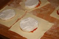 Place prepared cheese halves on dough squares....