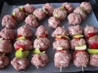 Put the skewers on a baking sheet lined with...