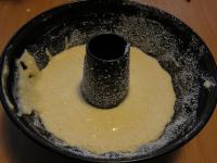 Grease the cake mould with butter and sprinkle...