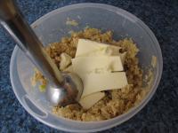 Add butter to the mixture and use a hand blender...