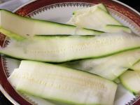 Wash the zucchini, partially peel, cut lengthwise...