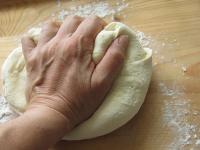 We tip off the dough on the floured plate a we...