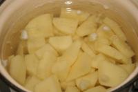 Cook peeled potatoes cut into pieces in salted...