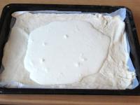 Transfer the spread dough with parchment paper...