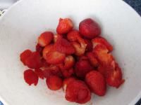 Remove leaves from strawberries, wash them and put...