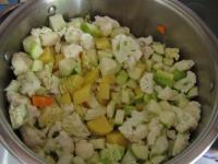 Add potatoes and zucchini cut into cubes to...