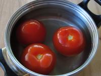 Meanwhile, pour hot water over the tomatoes. Let...