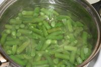 Cook frozen or fresh green beans pods in salted...