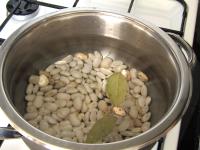 Place beans into the pan, pour in a water and let...