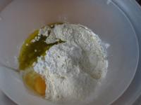 In a bowl pour both kind of flour, add sugar,...