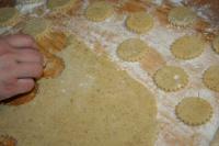 Use a rolling pin to spread the dough until it is...