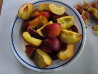 Remove the stones from peaches and cut them into...