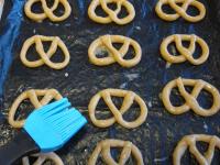 Carefully brush the pretzels with beaten egg....