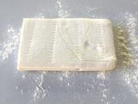 Use a rolling pin to spread the puff pastry on...