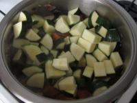 Add zucchini to sweet potatoes, mix and simmer...