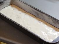 Add nuts to the dough and pour it evenly into the...