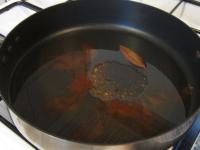 In a larger pan, heat the oil and fry the spices...