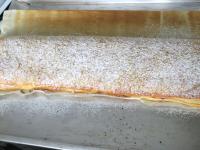 Sprinkle the baked strudel with sifted powdered...