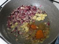 Add garlic, ginger and spices to the onion. Mix,...