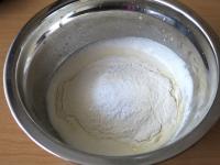 Add flour with baking powder and mix a smooth...