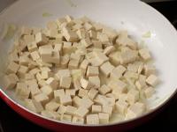 Cut tofu into smaller cubes and add to the onion....