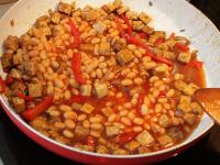 Add the beans in tomato sauce. Season with sugar,...