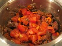 Add tomatoes to the meat with vegetables, ......