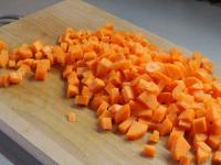 Clean and wash the carrots. Dice them....