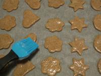 Put the gingerbreads on a baking sheet lined with...