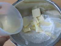 Give flour into a bowl, add sliced softened...