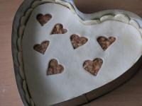 Cover with a dough with cutted hearts....