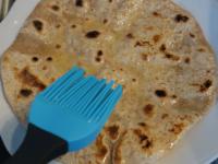 Spread chapatis with melted butter on one side ......