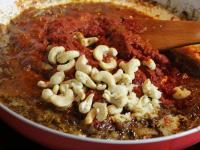 Add tomato paste and nuts. Overcook together....