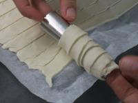 By partially folding, wrap the strips of dough...