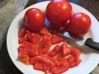 Wash the tomatoes and cut them finely....