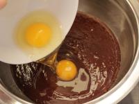 Add eggs to the melted lukewarm chocolate with...